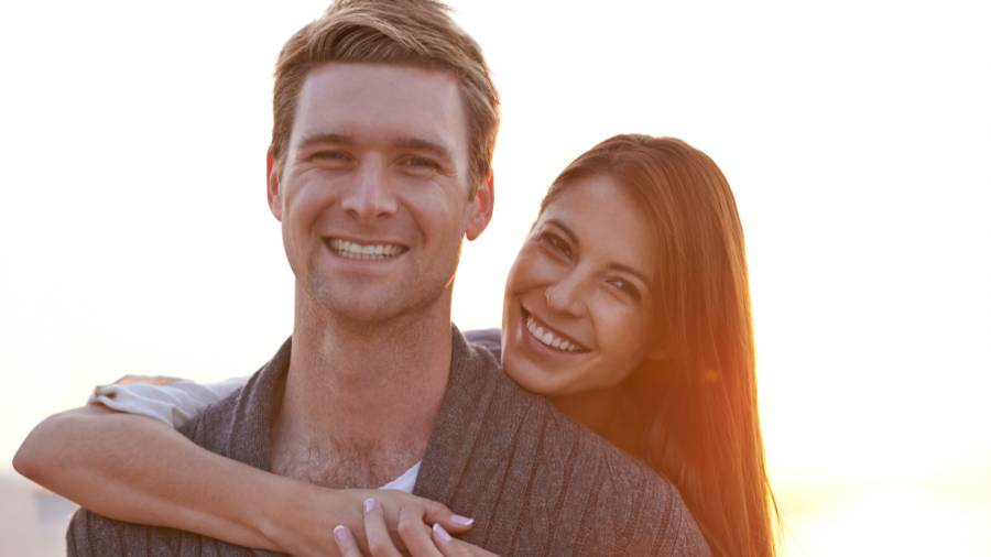 Couple smiling at the camera.