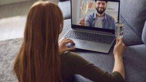 Online Date Dating. a Young Woman Is in a Living Room with a Laptop.