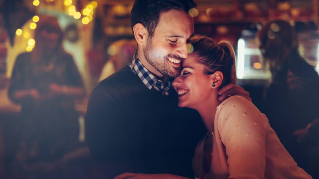 Romantic couple dating in pub at night