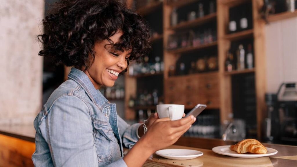 Smiling Woman Using Smart Phone