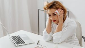 Woman Sitting at a Table Crying