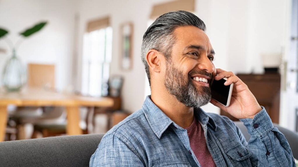 Happy Mid Aged Man Talking on Phone