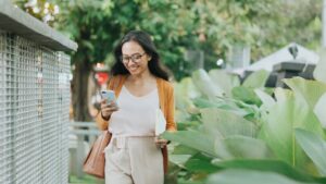Woman on Her Phone While Walking to Work