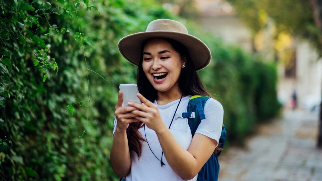 Girl looking at the phone and laughing
