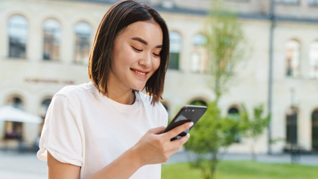 Young Beautiful Asian Woman Using Phone