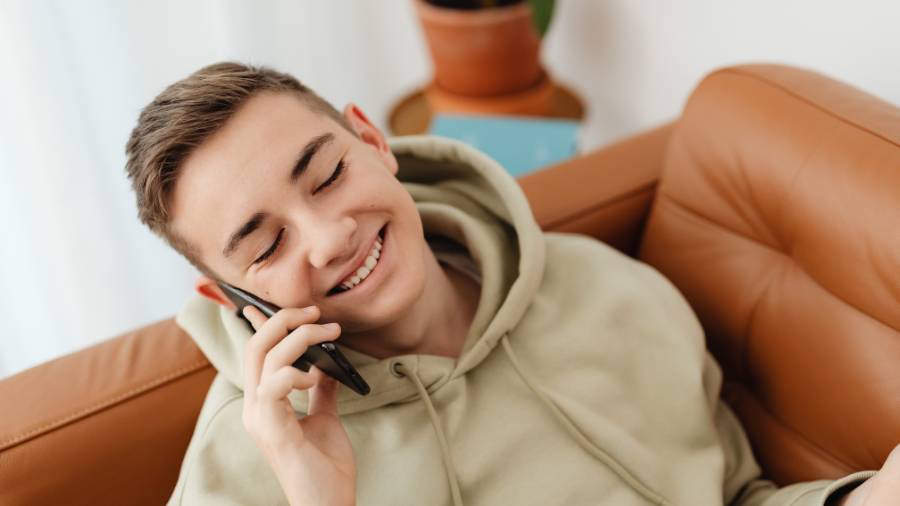 A Young Boy in Hoodie Jacket Talking on the Phone