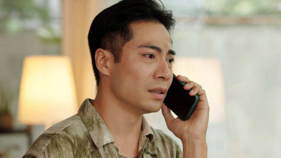 Worried Man Talking on the Phone